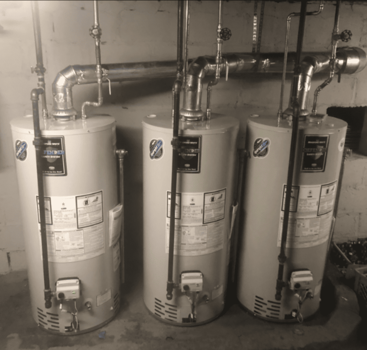 three hot water heaters in a utility closet.