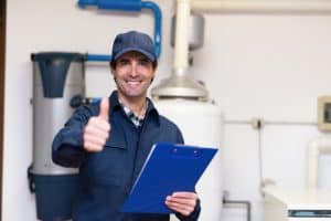 Licensed plumber performing maintenance in NYC plumbing service.