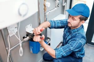 Coral image of a plumber repairing a water filtration system for plumbing services in Staten Island, NY.