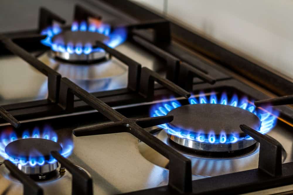 High-efficiency gas stovetop with blue flames for optimal home heating and cooking.